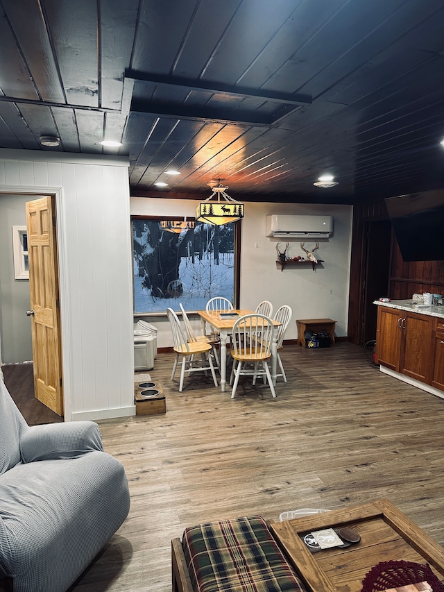 dining area with light hardwood / wood-style flooring, wood ceiling, and a wall mounted air conditioner