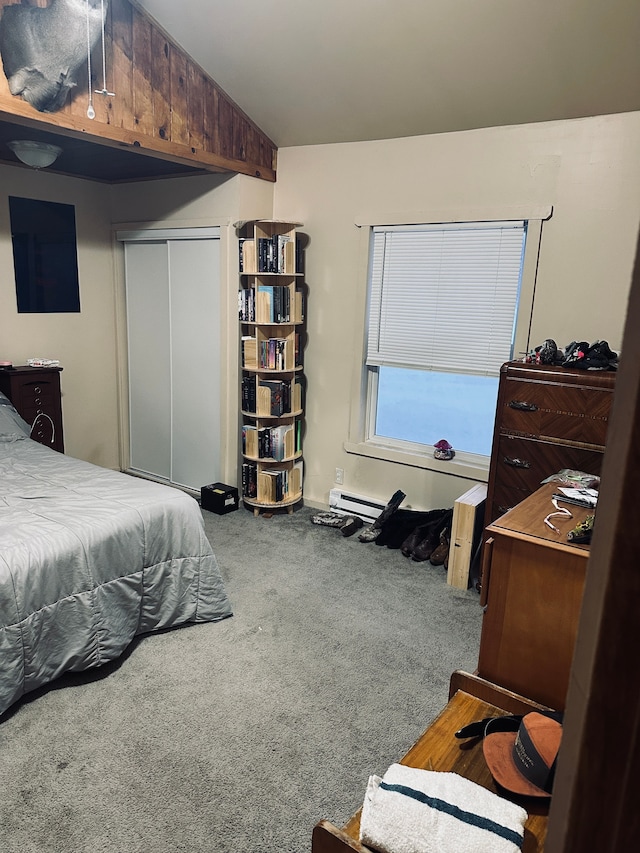 bedroom with carpet flooring, baseboard heating, a closet, and lofted ceiling