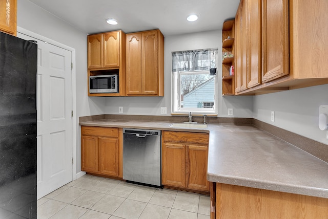 kitchen with light tile patterned floors, stainless steel appliances, and sink