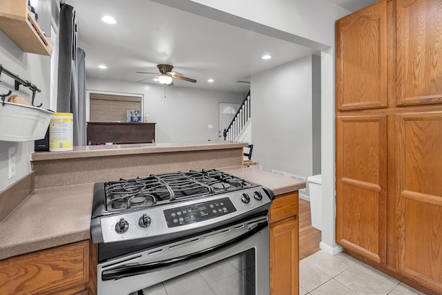 kitchen with gas stove, ceiling fan, and light tile patterned flooring