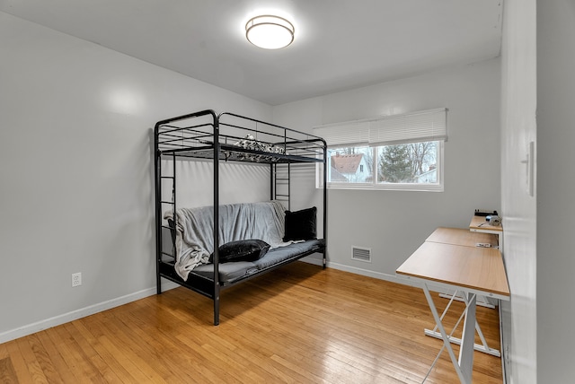 bedroom with hardwood / wood-style floors