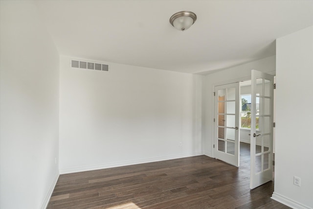 empty room with french doors and dark hardwood / wood-style flooring