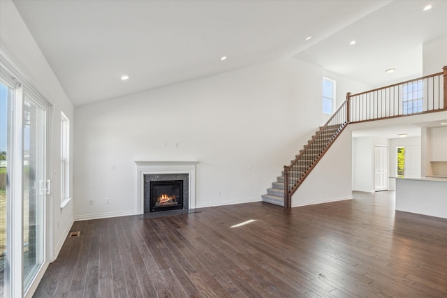 unfurnished living room with a healthy amount of sunlight and dark wood-type flooring