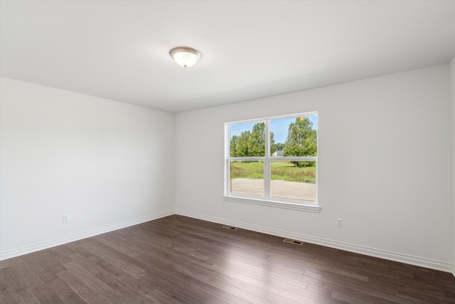 unfurnished room featuring dark hardwood / wood-style flooring