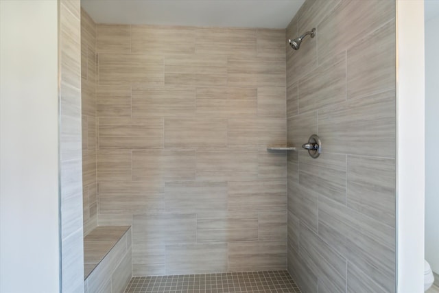 bathroom with tiled shower