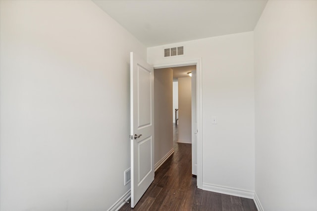 hallway featuring dark hardwood / wood-style flooring