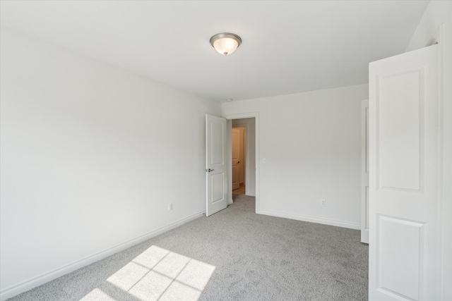 unfurnished room with light colored carpet