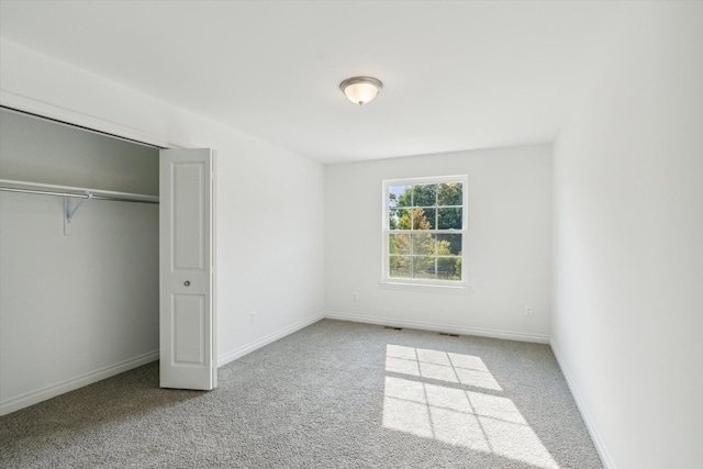 unfurnished bedroom with carpet flooring and a closet