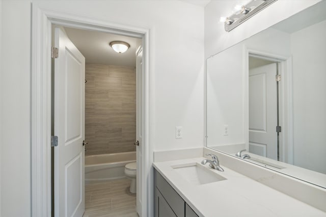 full bathroom with vanity, toilet, and tiled shower / bath