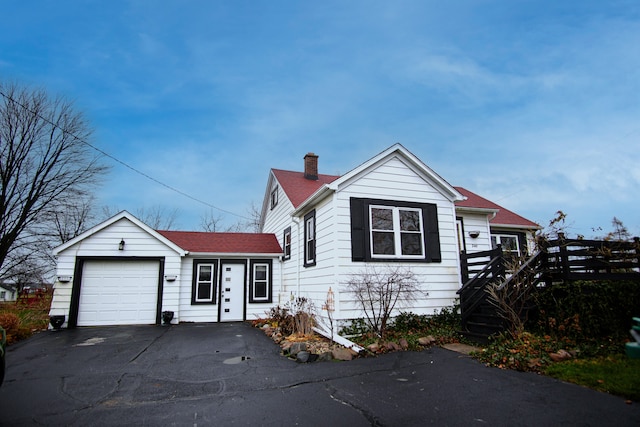 view of front facade with a garage and a deck