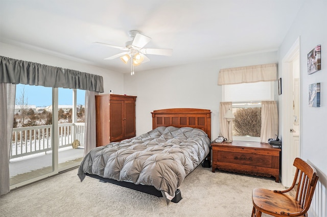 bedroom with access to outside, multiple windows, ceiling fan, and light carpet