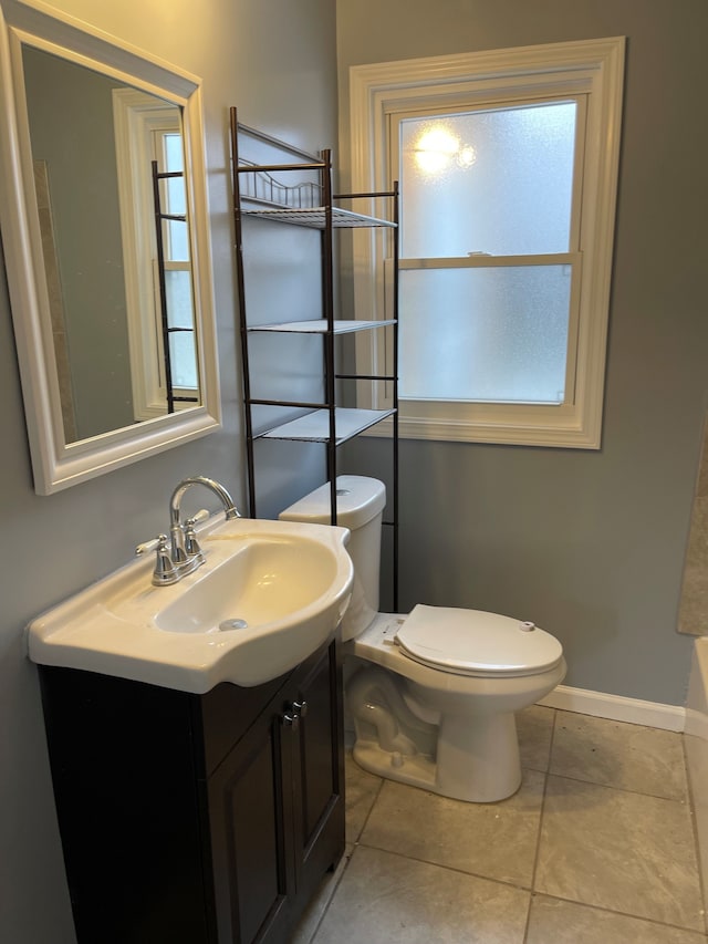 bathroom featuring tile patterned floors, vanity, and toilet