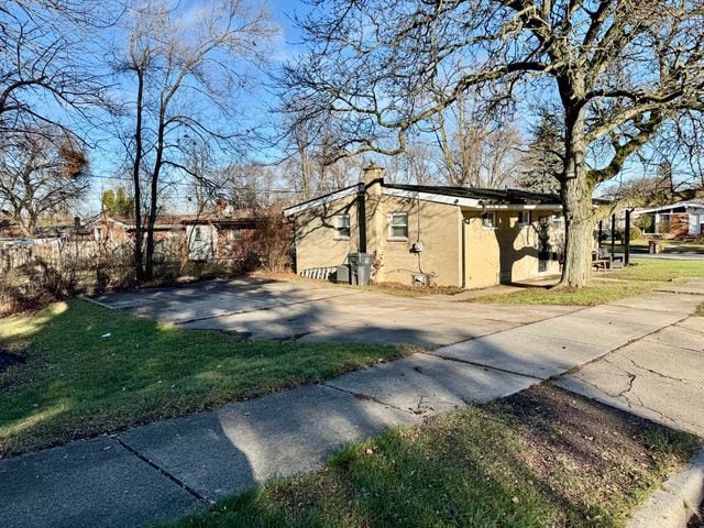 view of property exterior with a yard