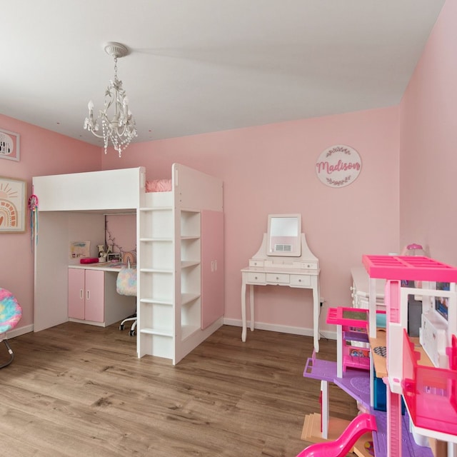 bedroom featuring an inviting chandelier and hardwood / wood-style flooring