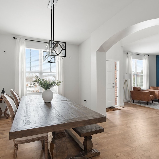 dining room featuring light wood-type flooring and an inviting chandelier