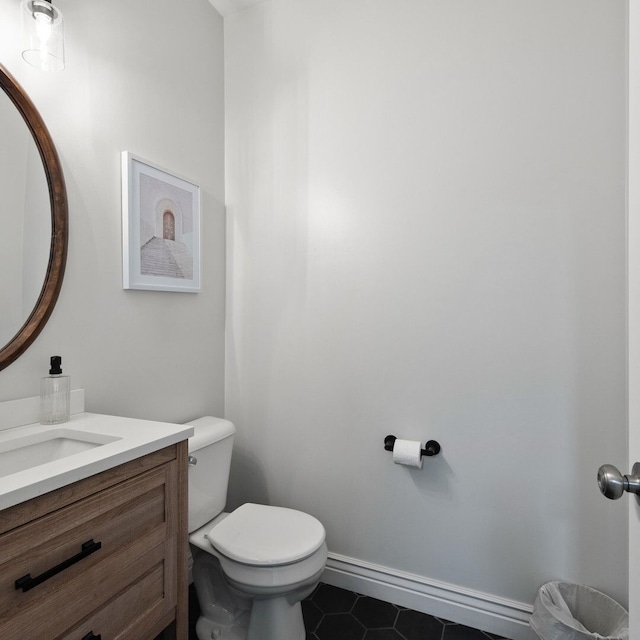 bathroom with vanity, tile patterned floors, and toilet