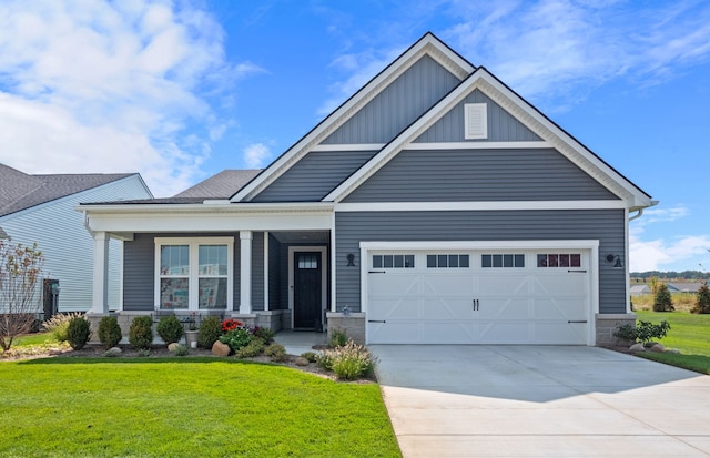 craftsman-style home with a garage, a front lawn, and covered porch