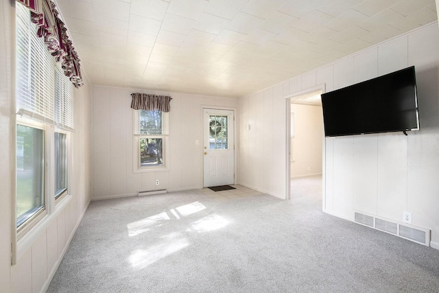 unfurnished living room featuring light carpet