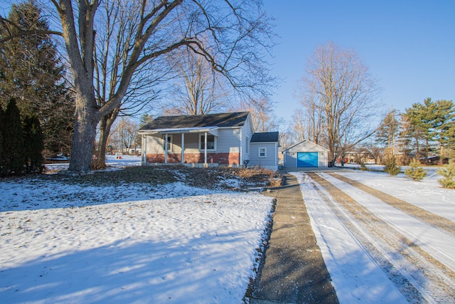 view of front of home featuring a garage, covered porch, and an outdoor structure