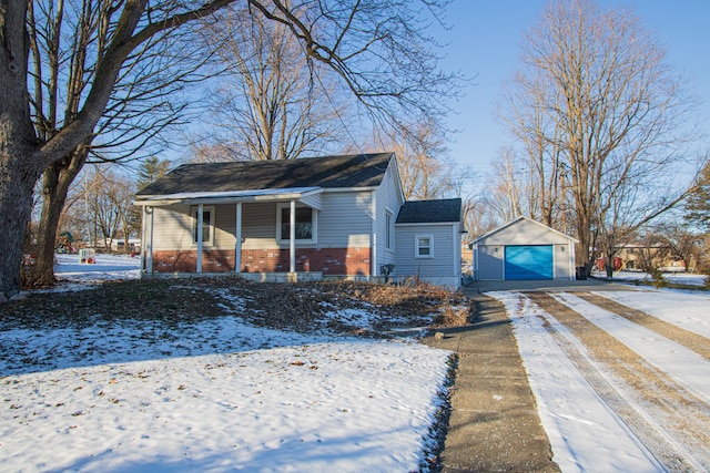 view of snow covered exterior featuring an outbuilding, a porch, and a garage