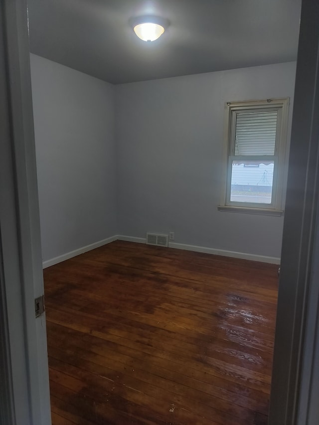 unfurnished room with dark hardwood / wood-style floors