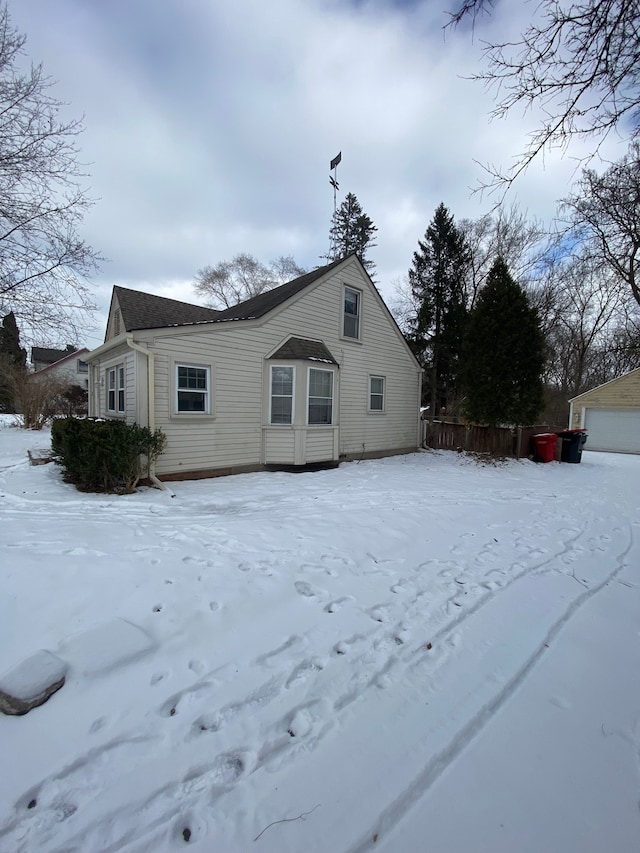 view of snow covered rear of property