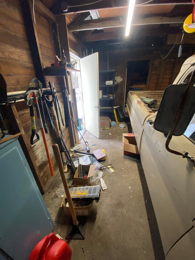 basement featuring wood walls