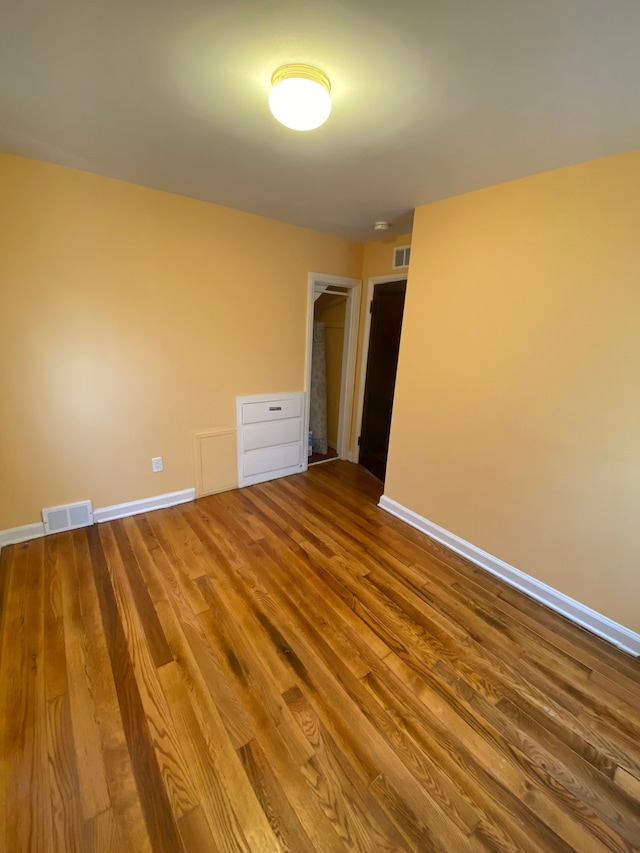 empty room featuring hardwood / wood-style flooring