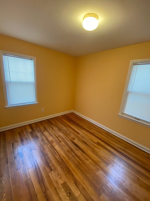 empty room with dark hardwood / wood-style floors