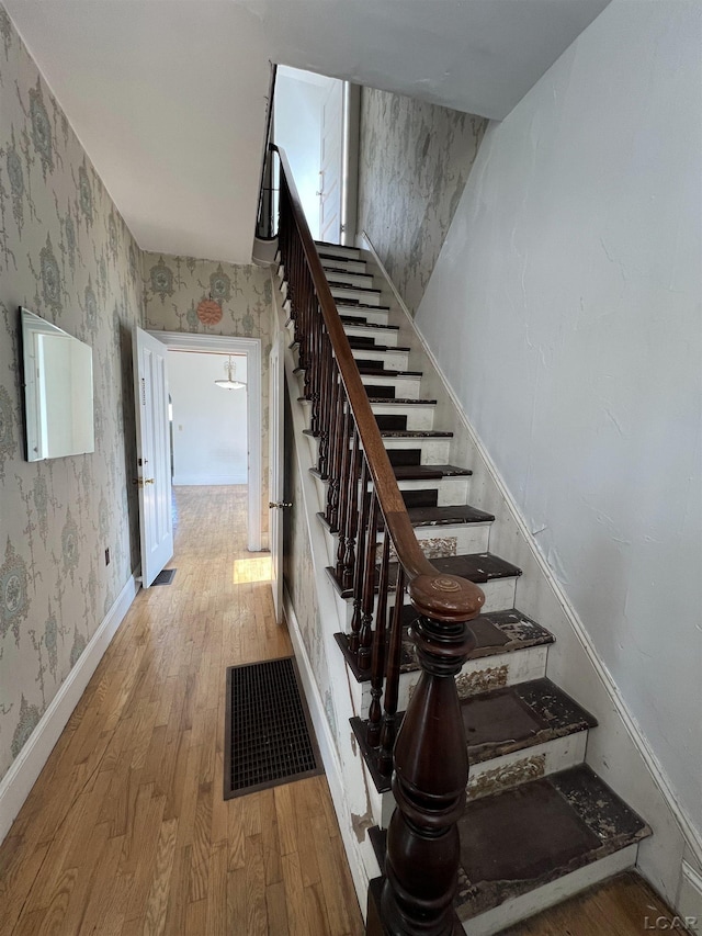 stairs featuring wood-type flooring