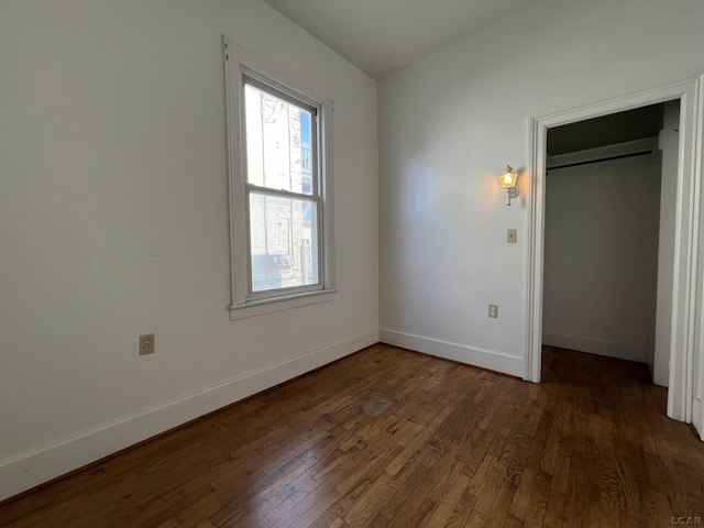 unfurnished bedroom with dark hardwood / wood-style floors