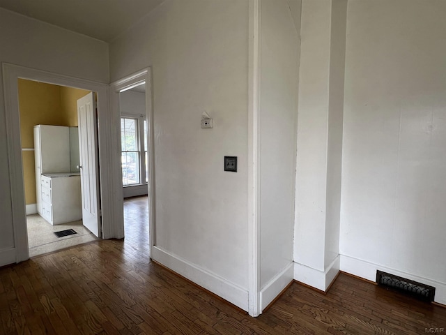 hall with dark wood-type flooring