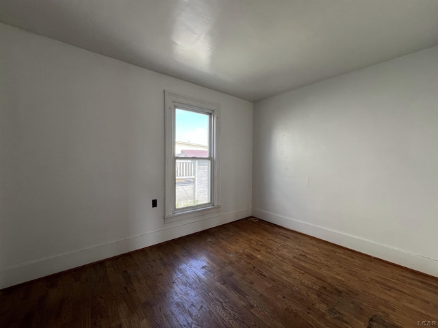 unfurnished room with dark hardwood / wood-style floors