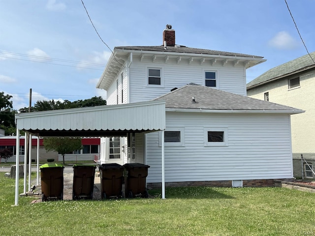 back of property featuring a yard