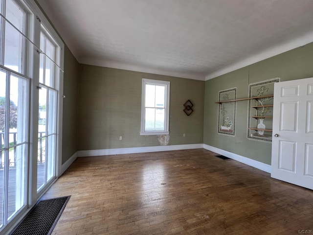 unfurnished room with hardwood / wood-style flooring