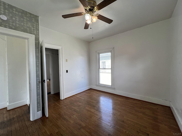 unfurnished bedroom with dark hardwood / wood-style floors and ceiling fan