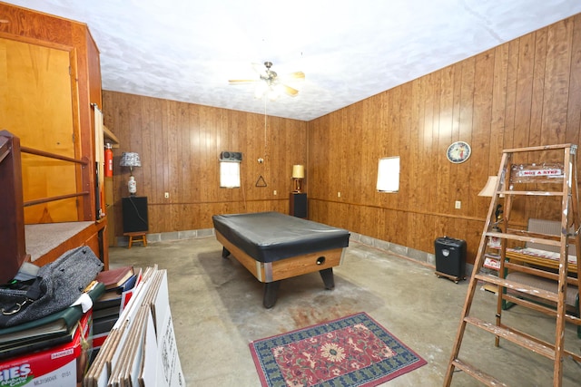 game room with ceiling fan, billiards, and wood walls