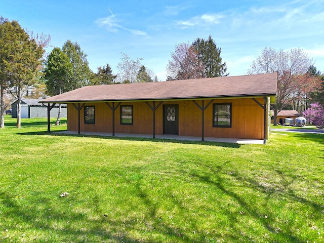 rear view of house featuring a yard