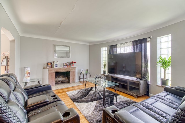 living room featuring hardwood / wood-style floors and a tiled fireplace