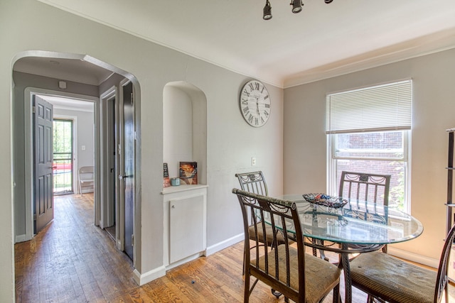 dining room featuring hardwood / wood-style flooring and ornamental molding