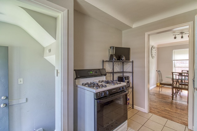 kitchen featuring gas range gas stove and light tile patterned flooring