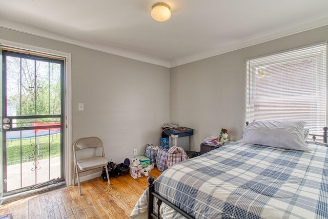 bedroom featuring hardwood / wood-style flooring and ornamental molding