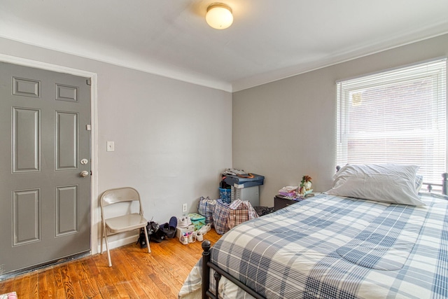 bedroom with hardwood / wood-style floors