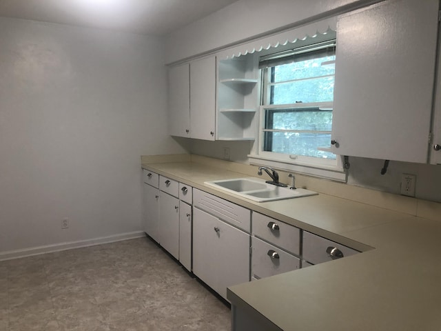 kitchen featuring white cabinetry and sink