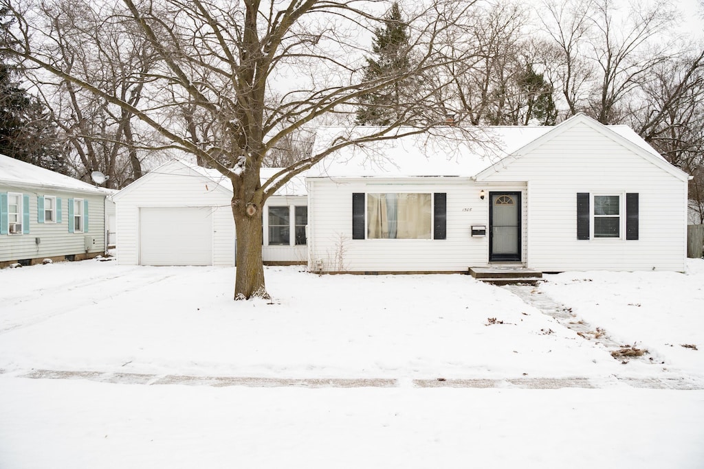 view of front of house with a garage and an outdoor structure