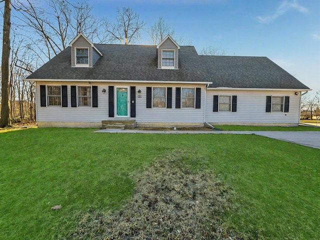 cape cod-style house featuring a front yard