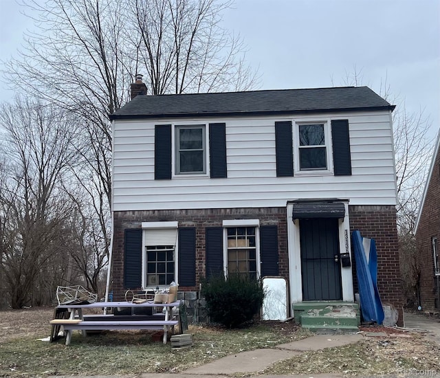 13136 Maiden St, Detroit, MI 48213 - view of front of home with brick siding, a chimney, and roof with shingles