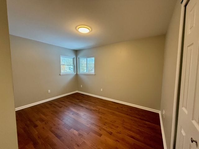 empty room featuring dark wood-type flooring