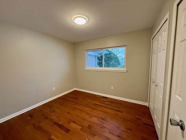 unfurnished bedroom featuring dark hardwood / wood-style floors