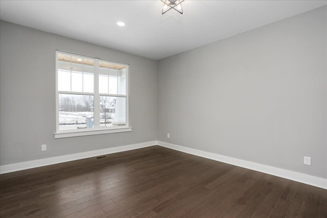 empty room with dark wood-type flooring